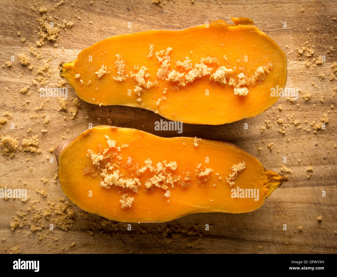 Two halves of cooked sweet potato with brown sugar Stock Photo Alamy