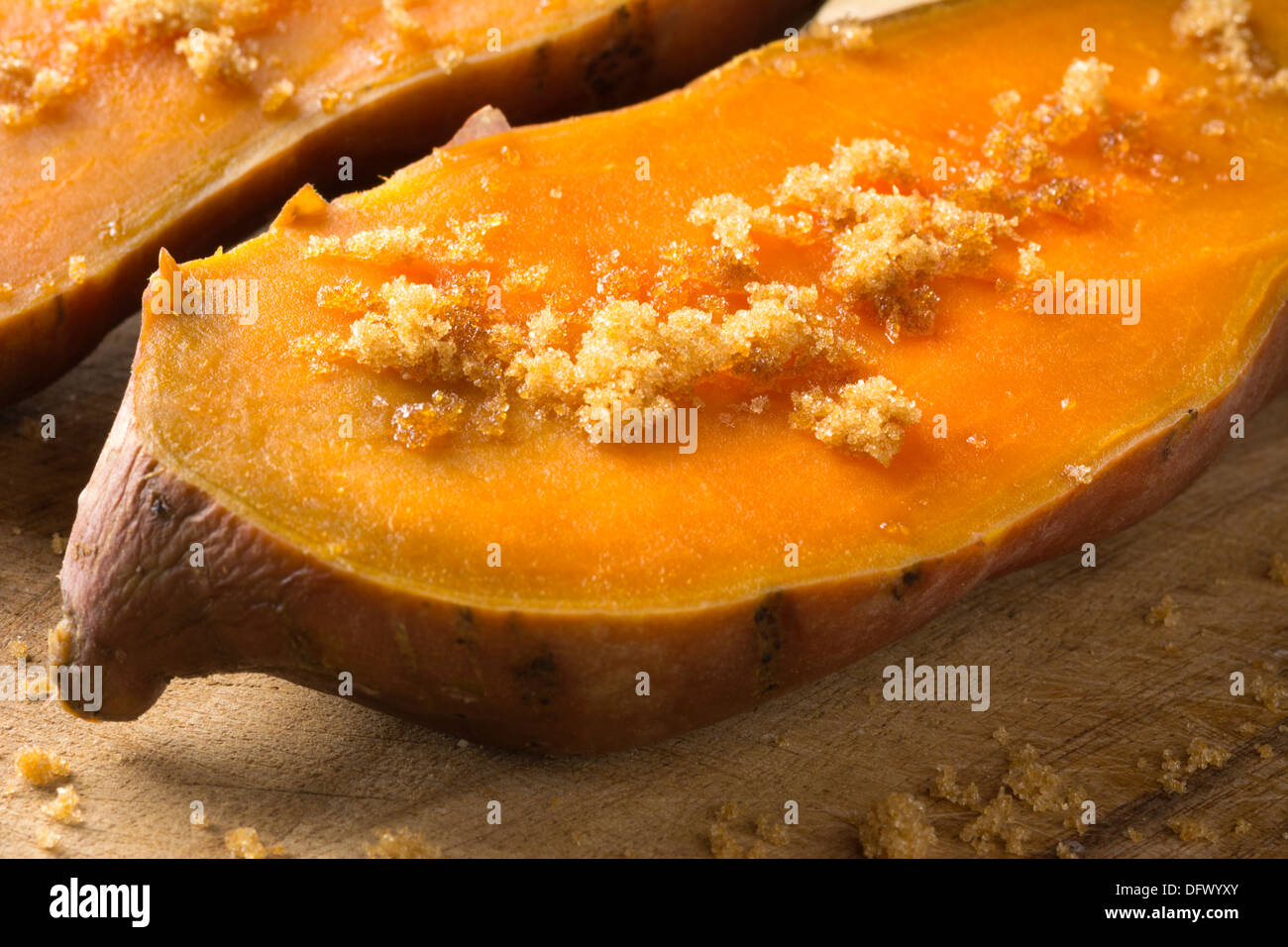 Two halves of cooked sweet potato with brown sugar Stock Photo
