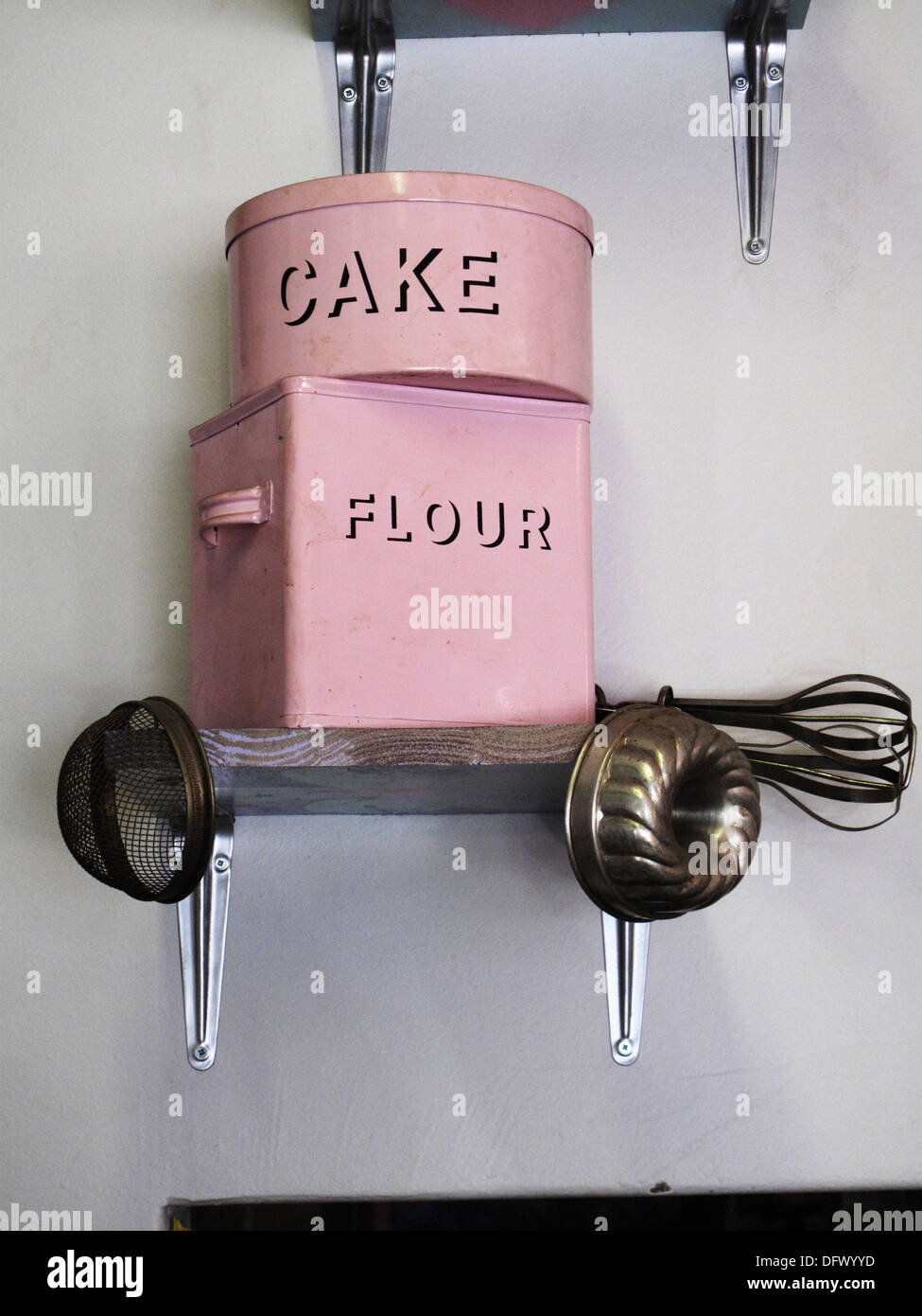 Cake and Flour Tins on Kitchen Shelf Stock Photo