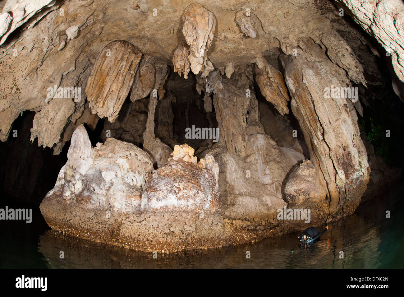 Snorkeler explores the spectacular Tomolol caves, southern Raja Ampat, West Papua, Indonesia. Stock Photo