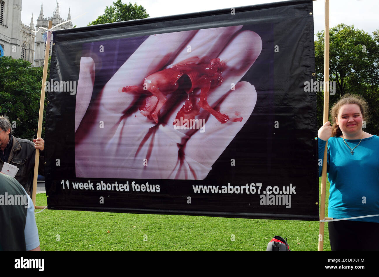 London UK, 9th Oct 2013 : Activist from Abort67 holding plastic replica of 11 week aborted foetus.. See Li / Alamy, Live News Stock Photo
