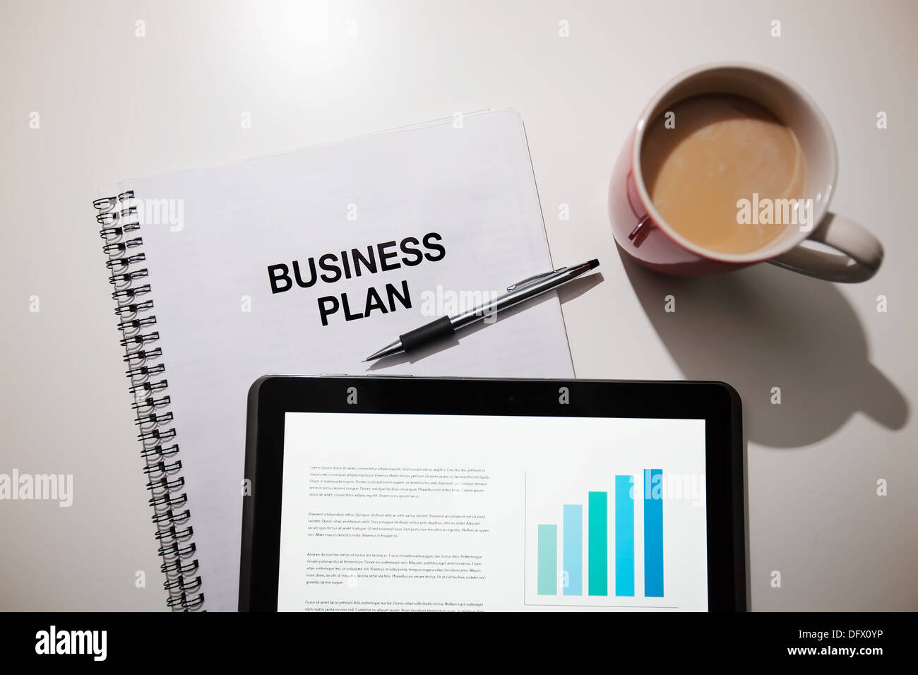 Business plan with touchscreen and coffee. Stock Photo