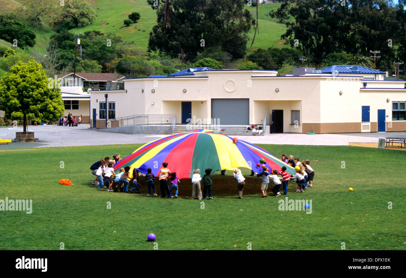 group of kids playing with colorful canvas at middle school in marin