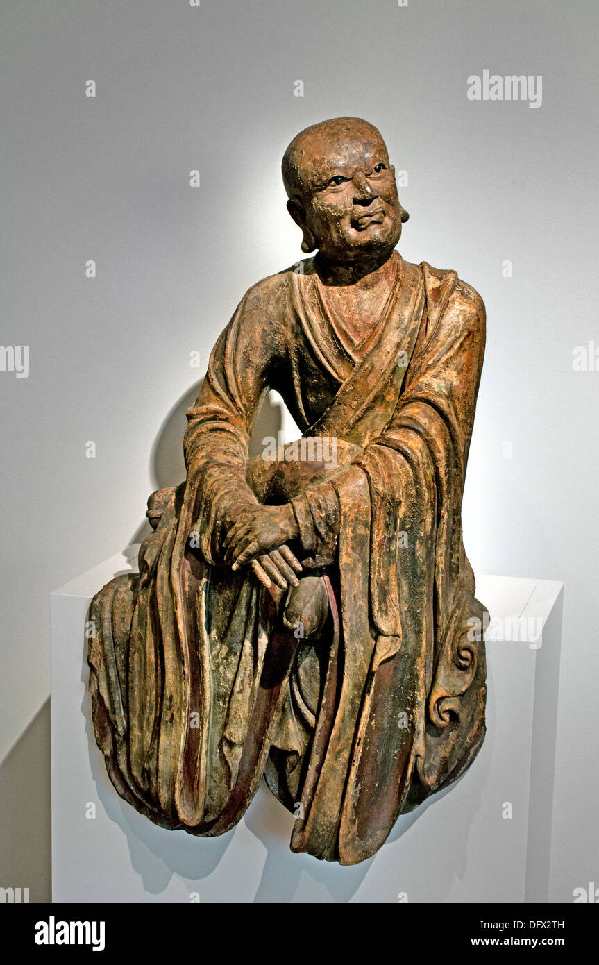 A Lohan ( follower of Buddha ) 13th - 14th century  China Chinese Museum sculpture statue Stock Photo