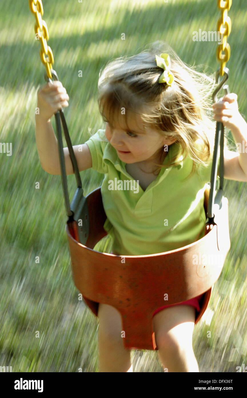 Toddler Girl Swinging Stock Photo Alamy