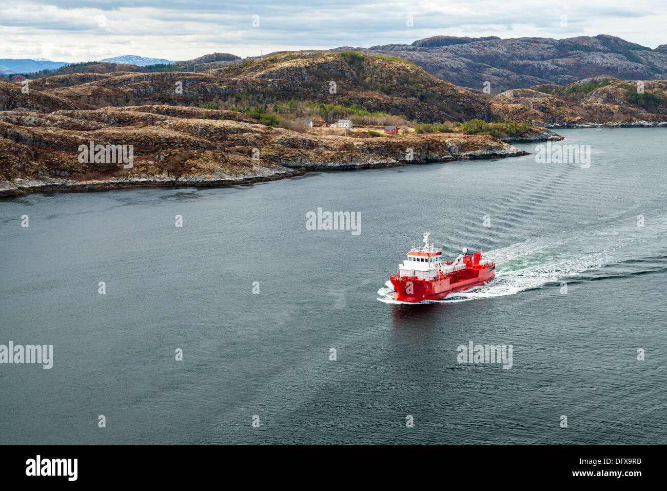 Small Norwegian red oil products tanker ship sails in fjord Stock Photo