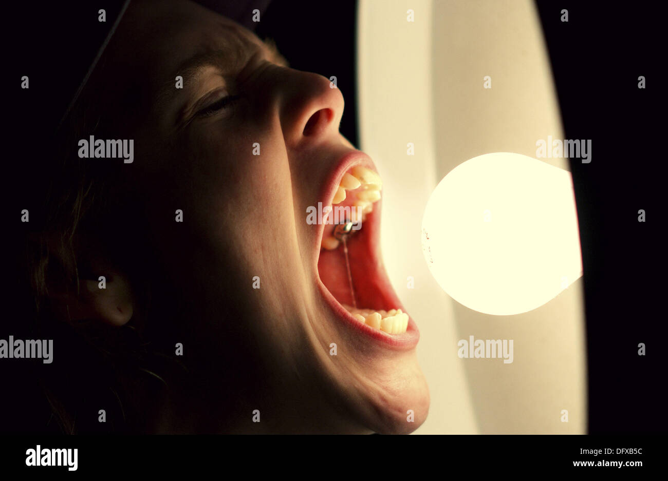 Mouth eating light bulb Stock Photo - Alamy
