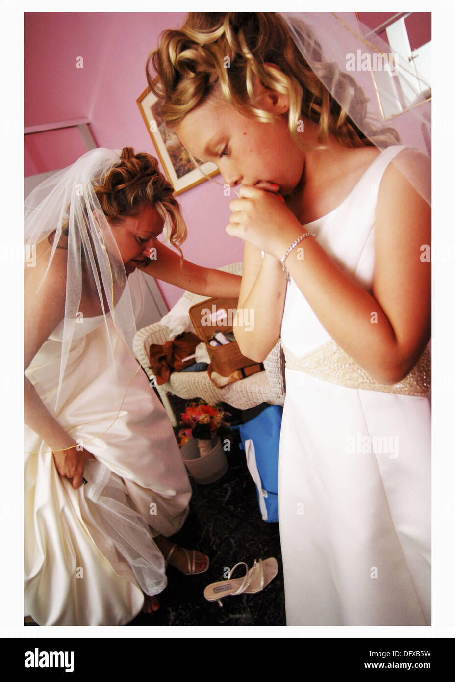 Flower girl and bride putting on shoes Stock Photo Alamy
