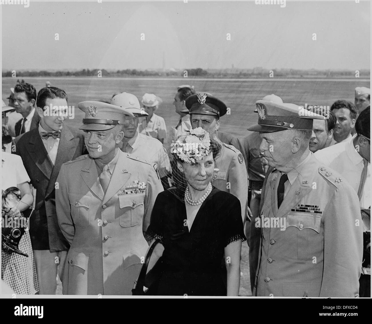 Photograph of General Dwight D. Eisenhower, his wife Mamie, and General George C. Marshall, at the airport in... 199127 Stock Photo