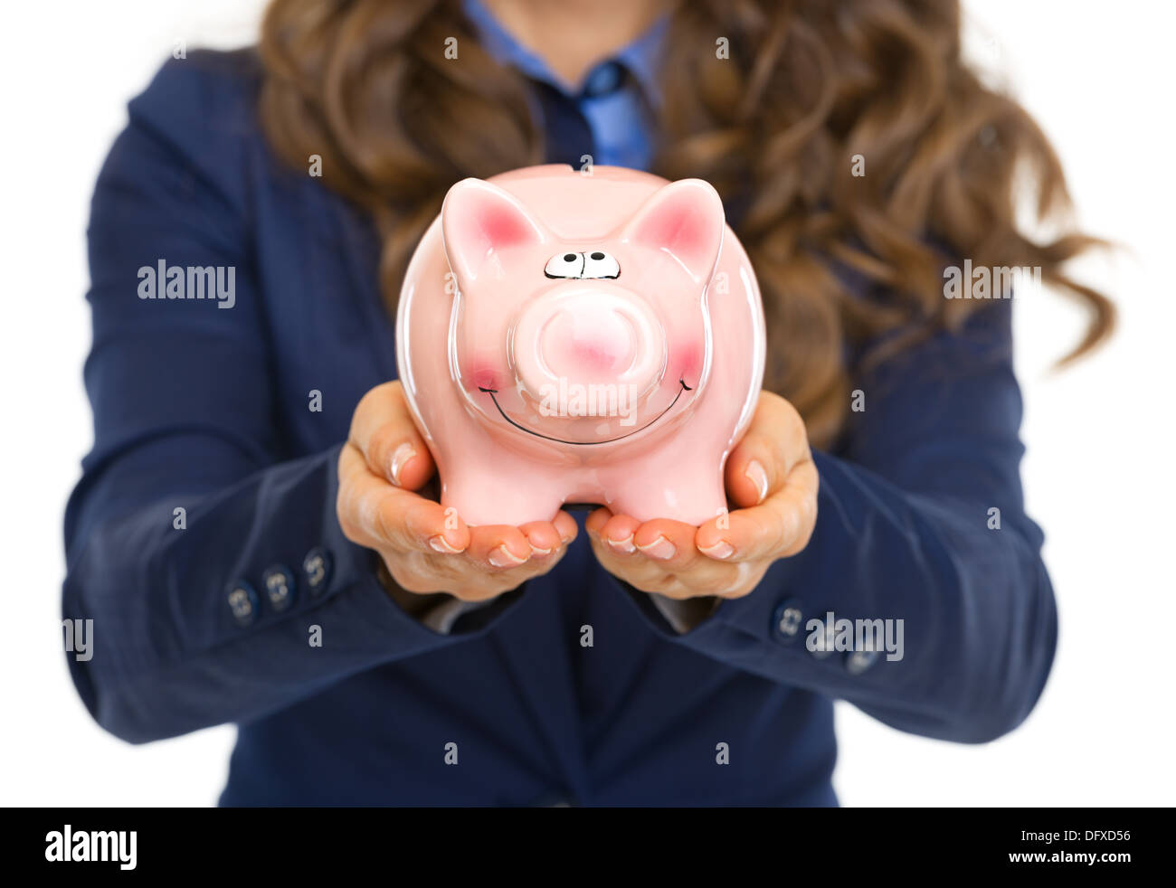 Closeup on business woman showing piggy bank Stock Photo - Alamy