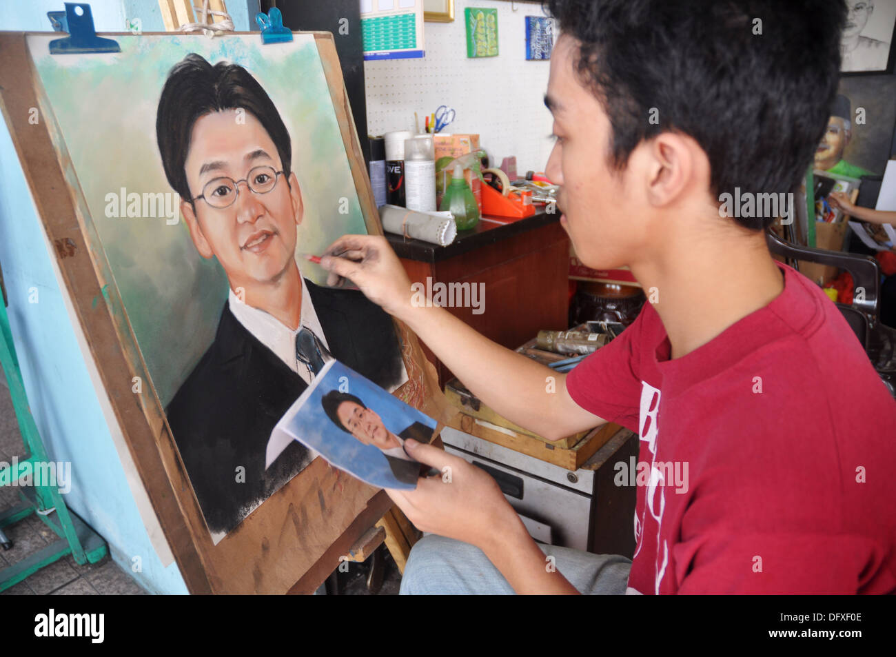 Kuala Lumpur (Malaysia) painter at work, drawing a portrait from a
