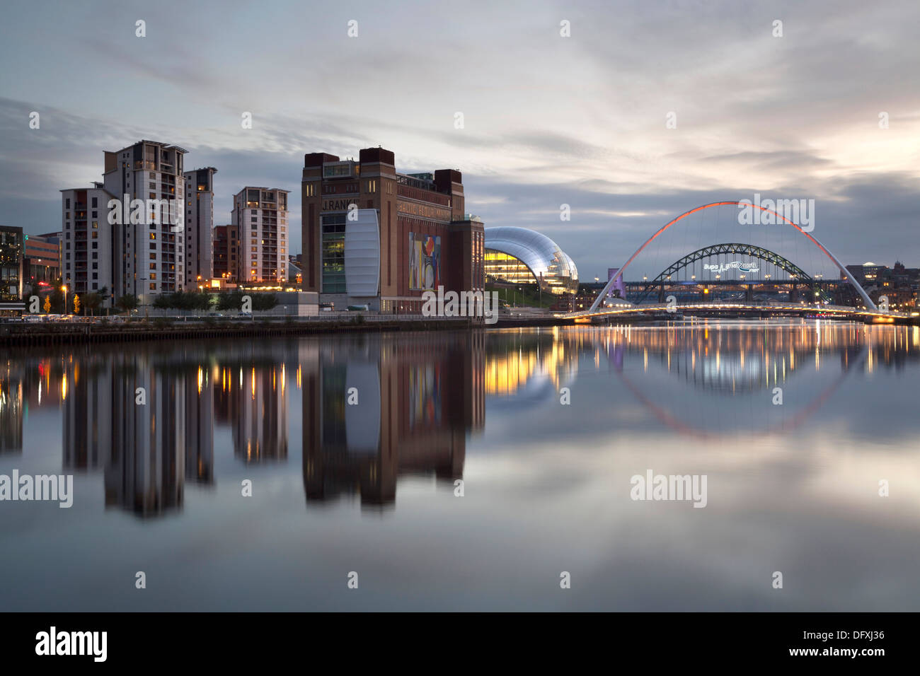 The Newcastle and Gateshead Quayside reflected in the River Tyne at dusk. Stock Photo