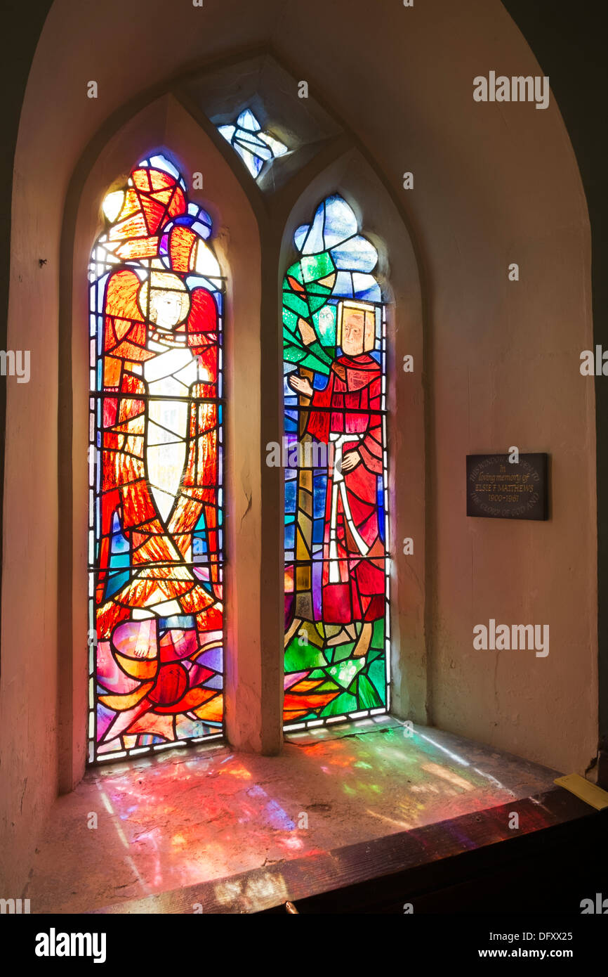 Light through a memorial stained glass window inside St Leonard's Church, Cholesbury, Bucks UK Stock Photo