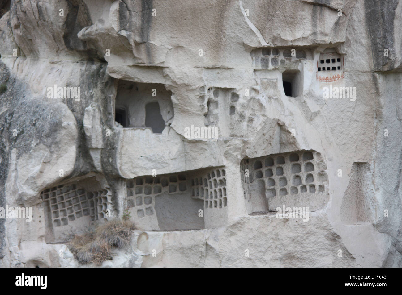 Rooms and houses carved out of the rock face in Goreme in Turkey. Stock Photo