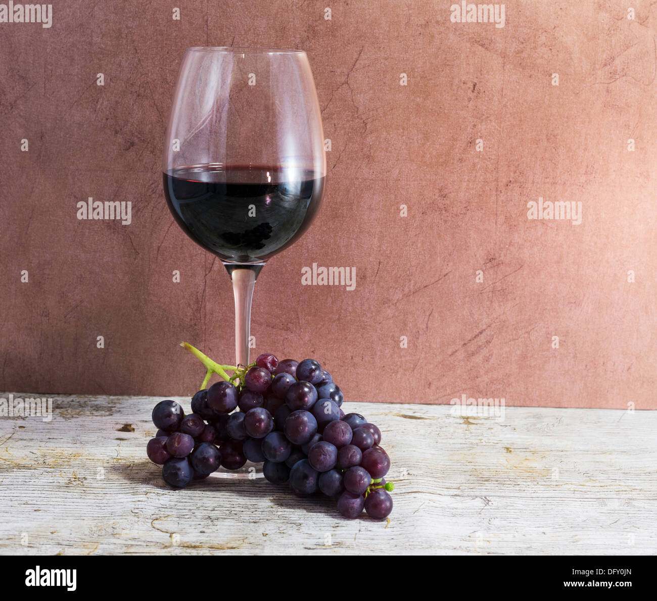 red wine and grapes on wooden table Stock Photo
