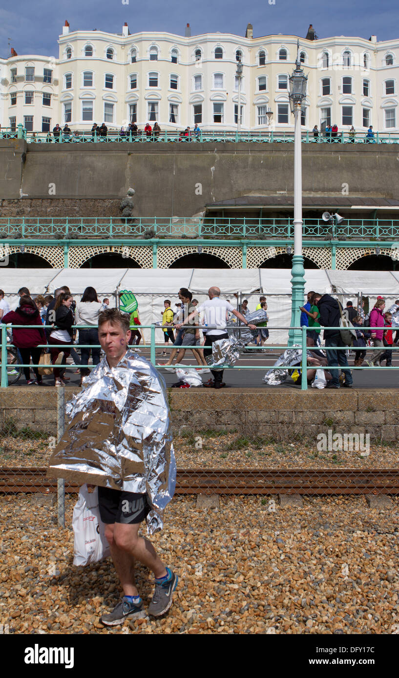 Finisher in foil blanket at the end of the Brighton Marathon. Stock Photo