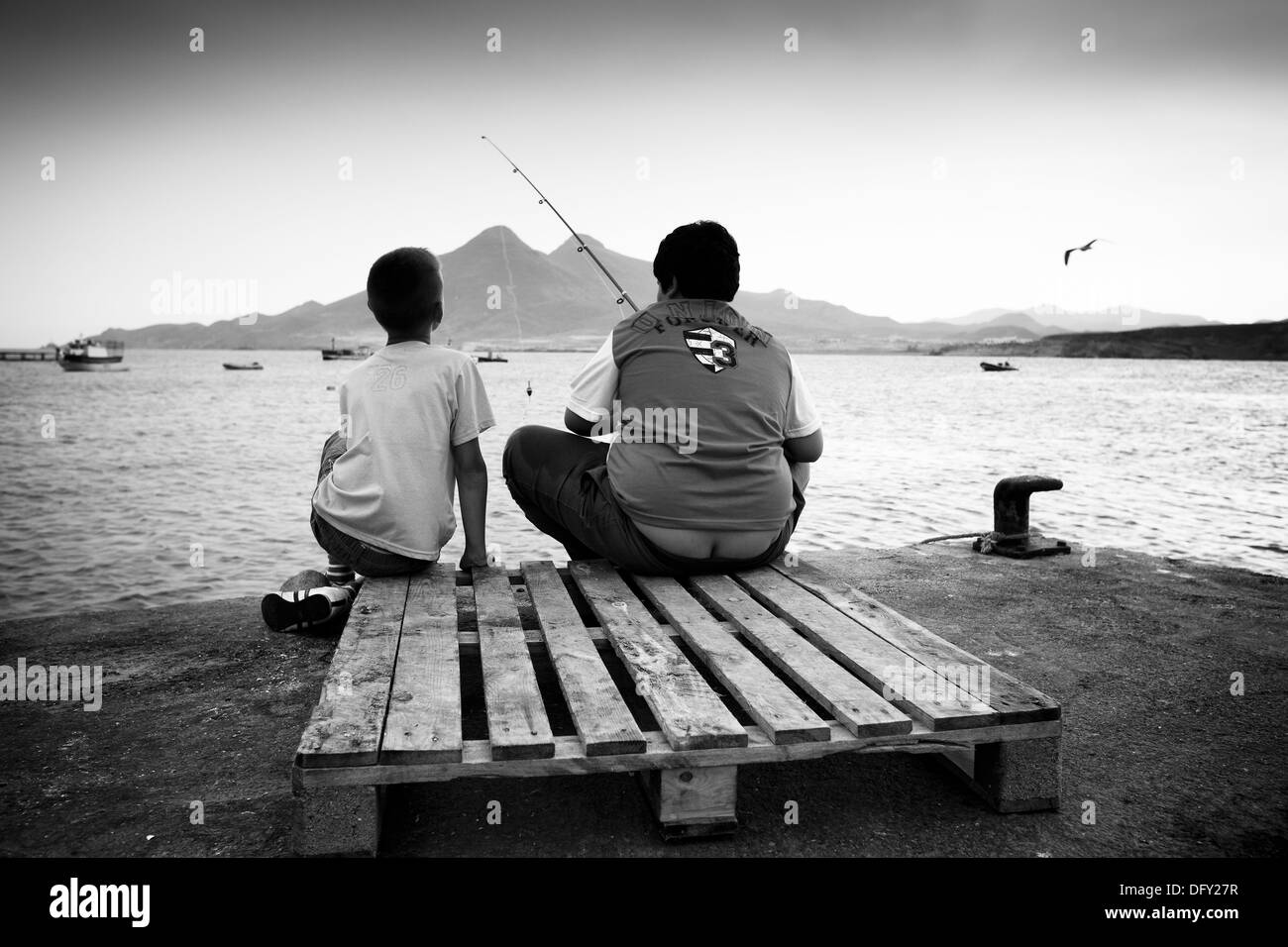 Two boys fishing Black and White Stock Photos & Images - Alamy