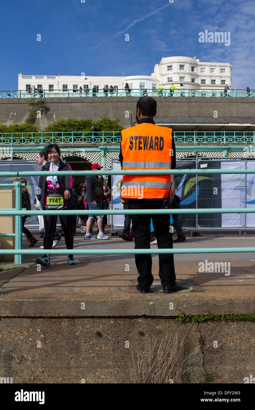 A steward at the finishers' area of the Brighton Marathon. Stock Photo