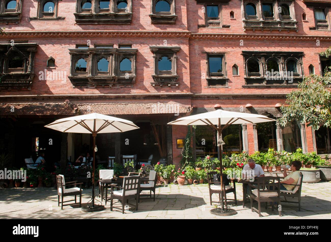 courtyard cafe in the sun at Dwarikas Resort in Kathmandu, Nepal Stock