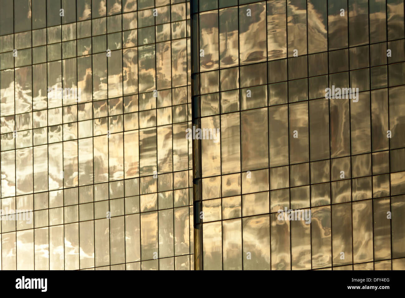 Clouds reflected in windows of modern office building Stock Photo - Alamy