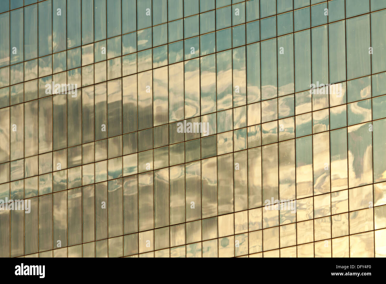 Clouds reflected in windows of modern office building Stock Photo - Alamy