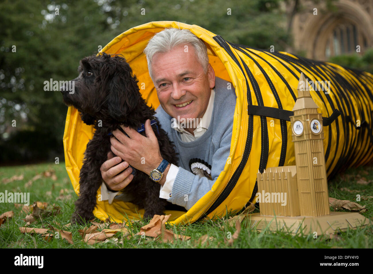 London, UK. Thursday 10th October 2013. The winner Alan Duncan MP and Noodle, a Cocker Spaniel / Poodle cross. MPs and their dogs competing in the Westminster Dog of the Year competition celebrates the unique bond between man and dog - and aims to promote responsible dog ownership. Credit:  Michael Kemp/Alamy Live News Stock Photo