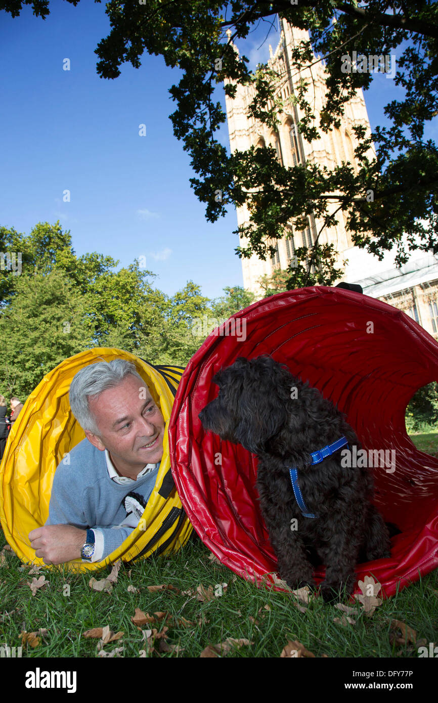 London, UK. Thursday 10th October 2013. The winner Alan Duncan MP and Noodle, a Cocker Spaniel / Poodle cross. MPs and their dogs competing in the Westminster Dog of the Year competition celebrates the unique bond between man and dog - and aims to promote responsible dog ownership. Credit:  Michael Kemp/Alamy Live News Stock Photo