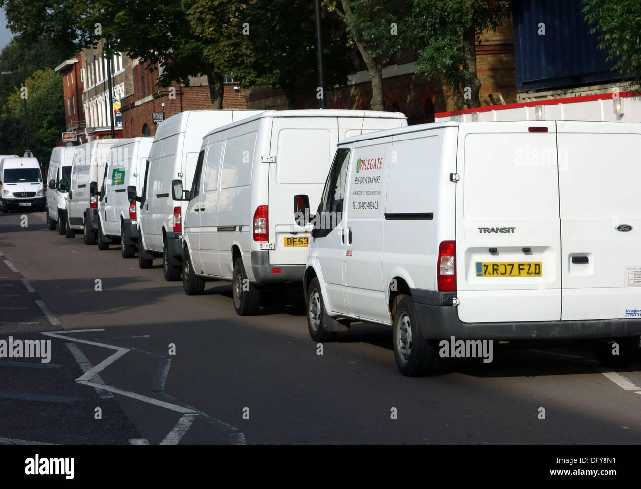 Row of white vans parked in London street Stock Photo - Alamy