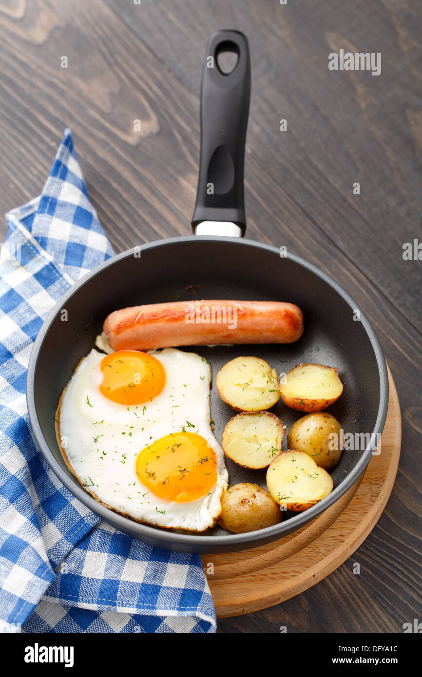 Breakfast with eggs, sausage and potato Stock Photo