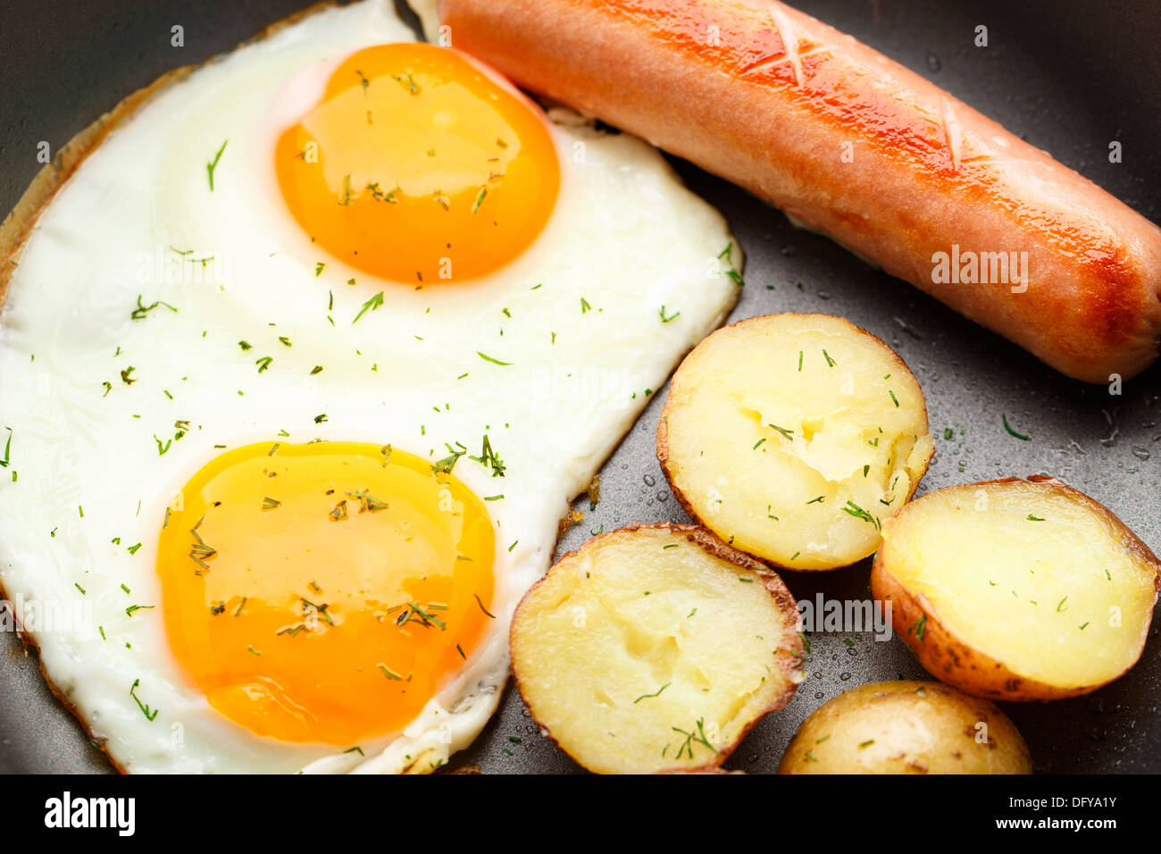 Breakfast with eggs, sausage and potato Stock Photo