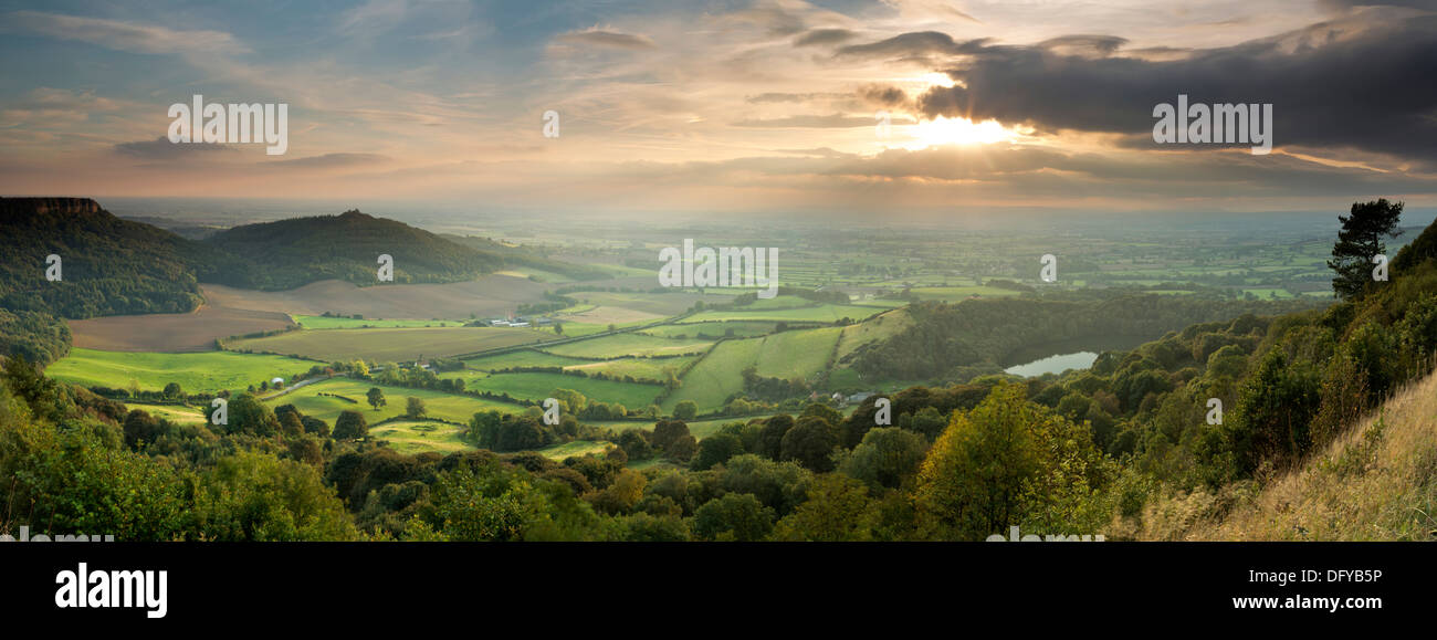 A panoramic landscape image of The Vale of York, Lake Gormire, Hood Hill, and Roulston Scar, from Sutton bank on the North York Stock Photo