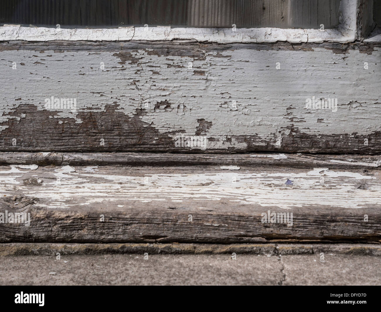 Old window sill and frame with weathered paint needing repainting Stock