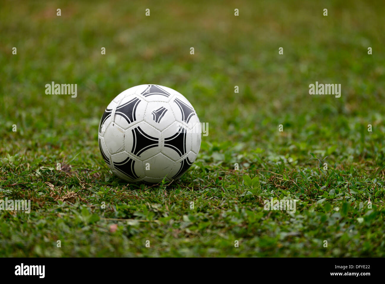 A football on a patch of grass Stock Photo