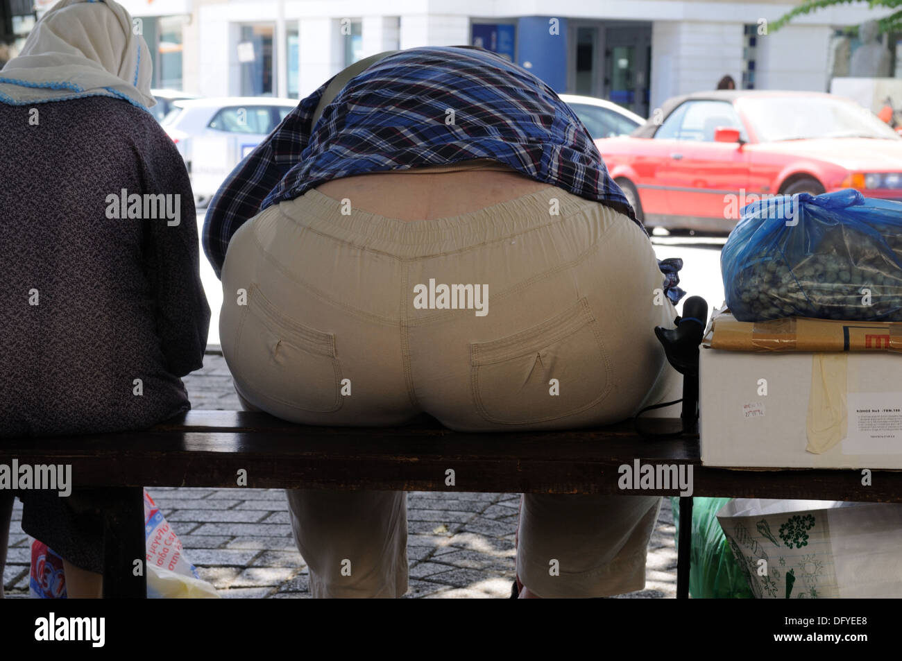 Bottom of an obese fat  woman sitting on a bench Stock Photo