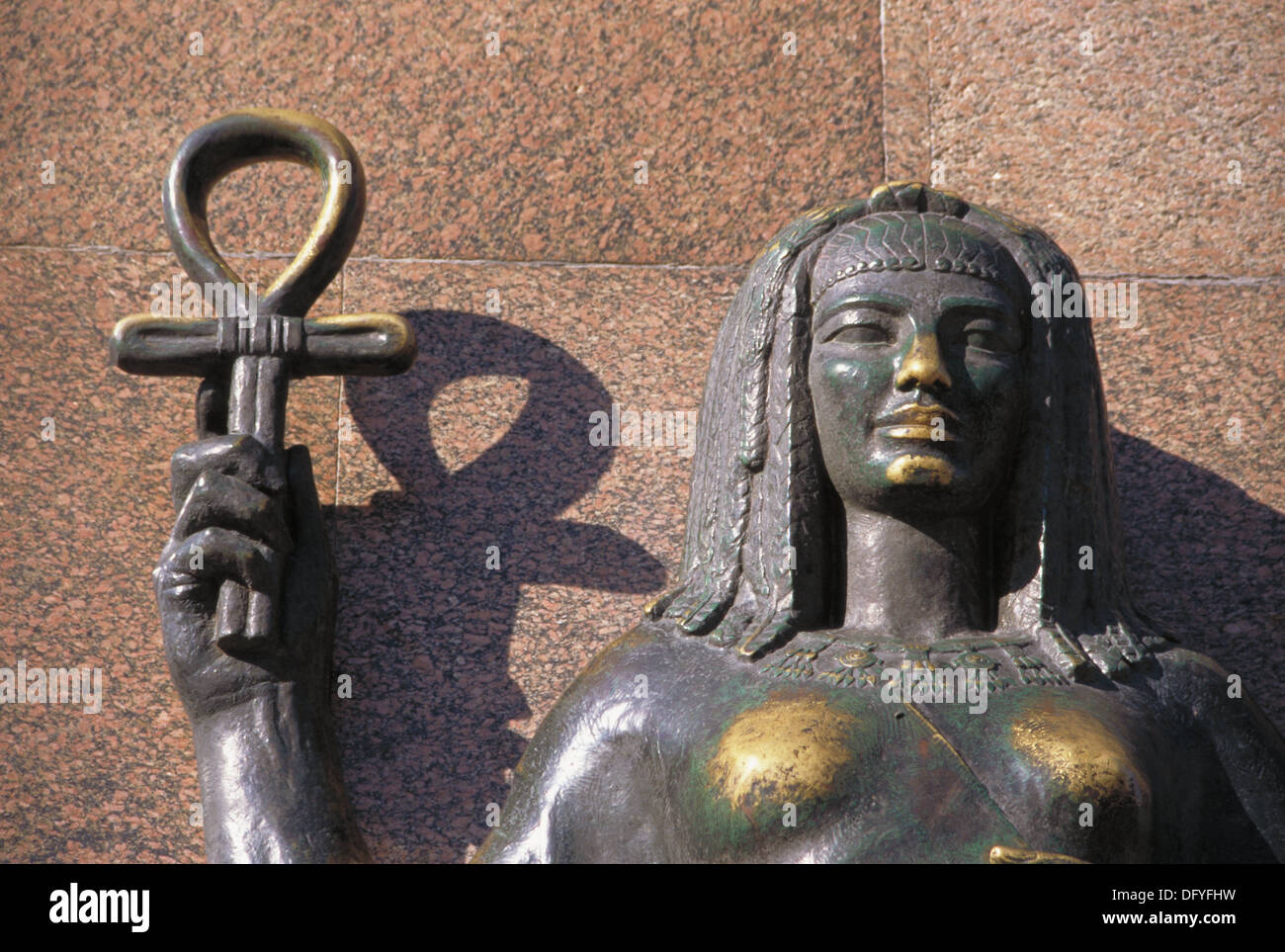 Female statue holding an ankh or ansate cross, an ancient hyerogliph
