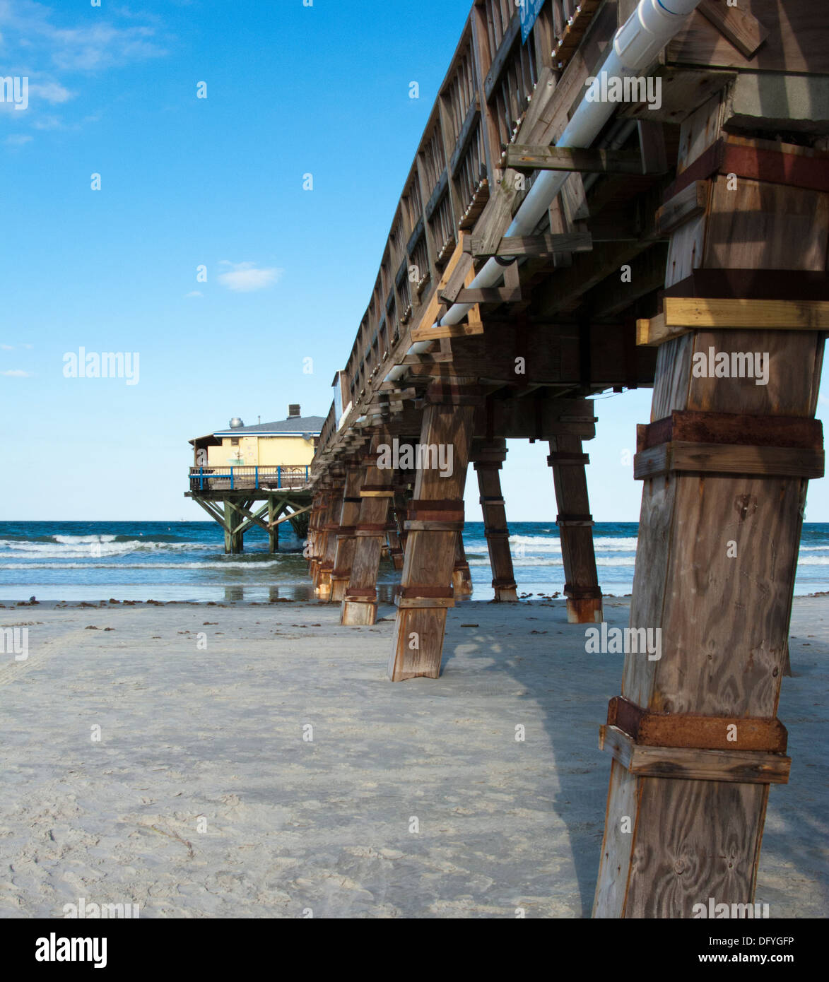 Legs of wooden pier in Daytona beach shores Florida Stock Photo