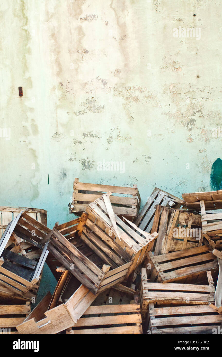 Wooden crates. Pile of old wooden crates against the wall Stock Photo
