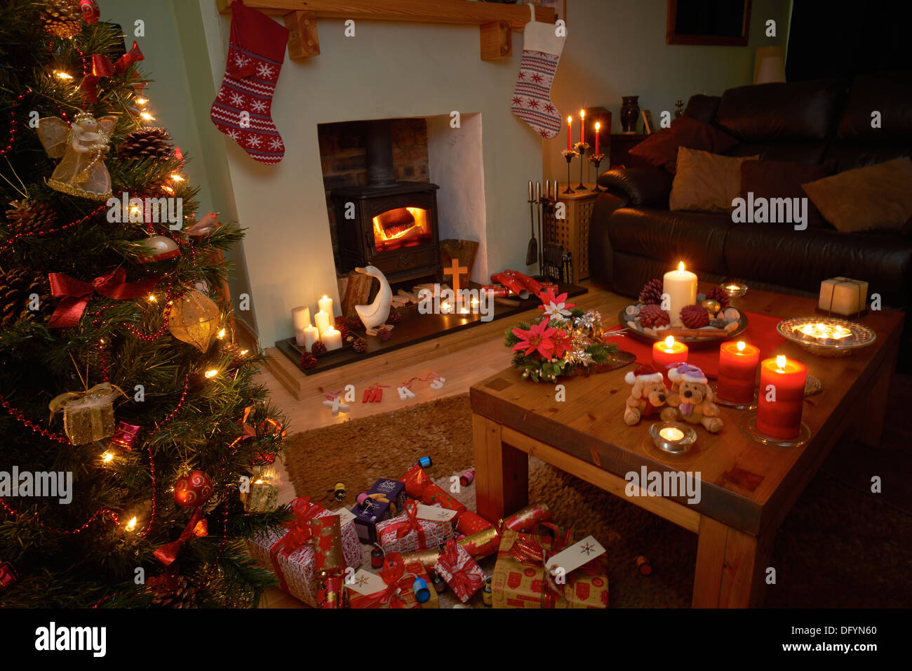 A Christmas tree scene at night with lit candles and fire. Stock Photo