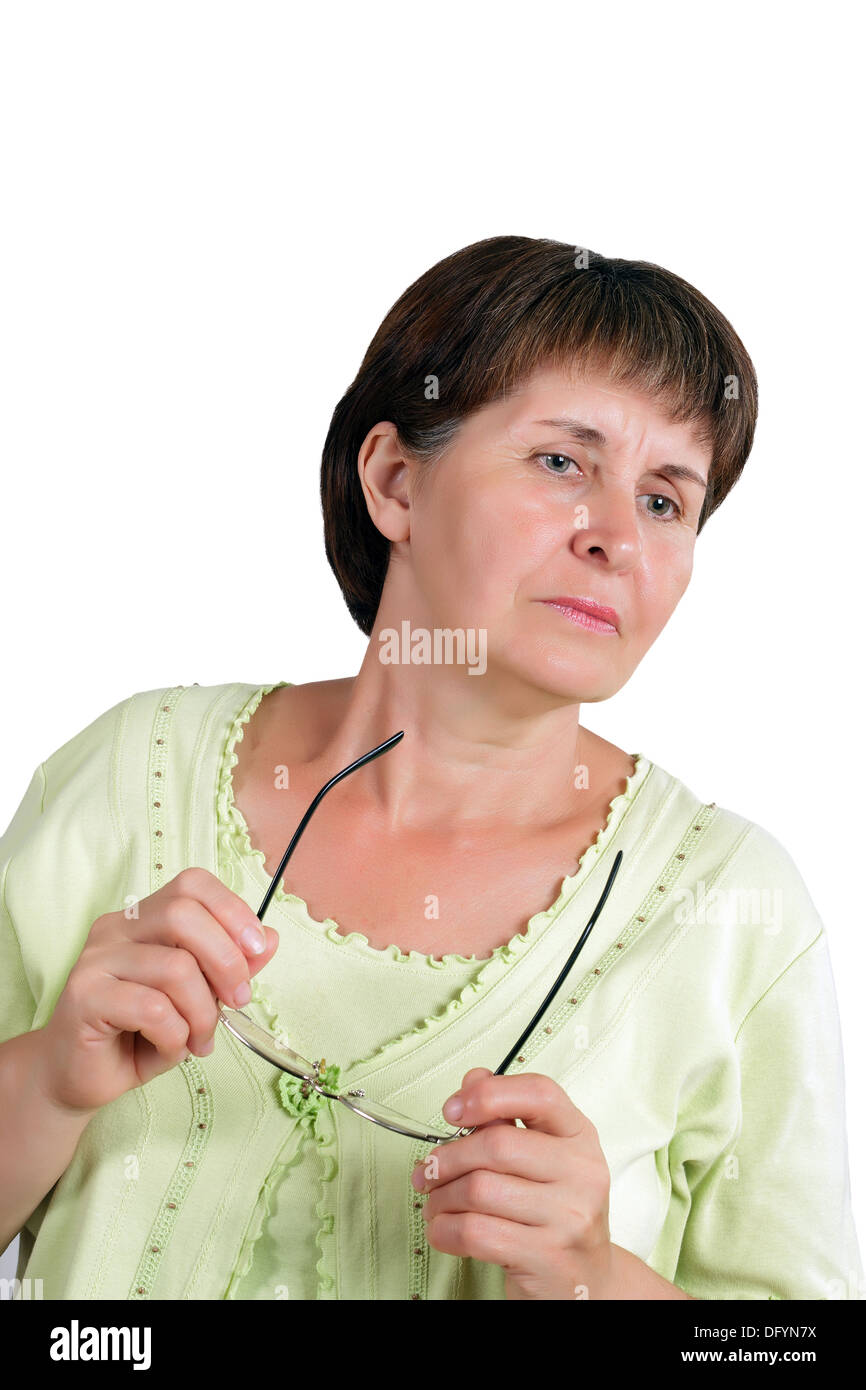 Strict woman in middle age with glasses in hands Stock Photo