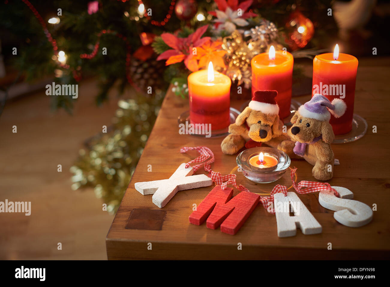 A Christmas tree scene with two teddy bears with lit candles. Stock Photo
