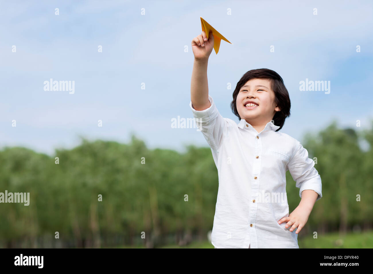 Happy boy playing paper airplane in the open air Stock Photo - Alamy
