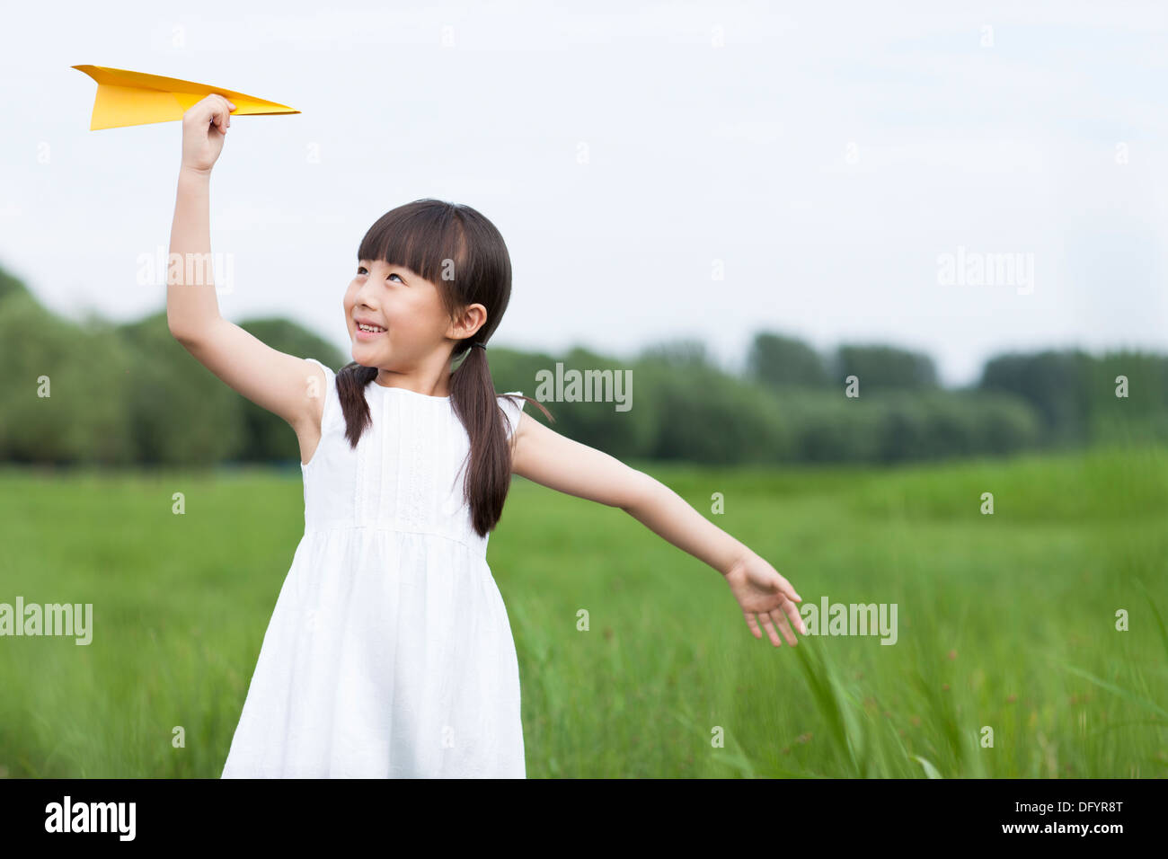 Happy girl playing paper airplane in the open air Stock Photo - Alamy