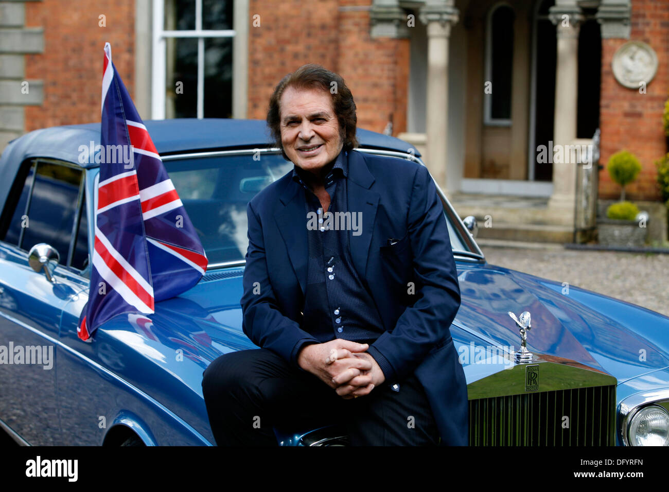 British pop singer Engelbert Humperdinck poses for a photograph next to his car and a Union Jack flag during a photocall Stock Photo