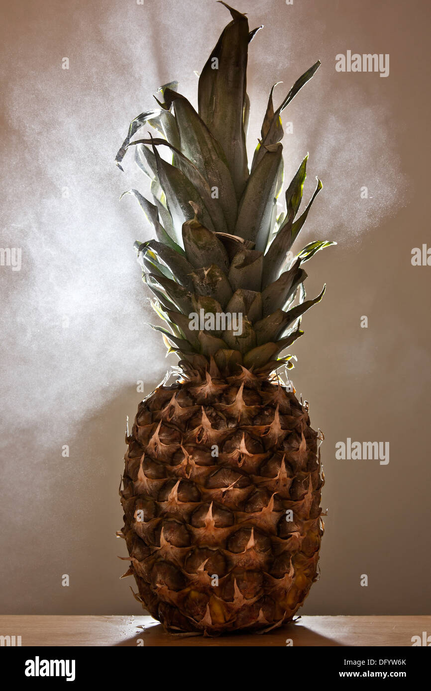 A pineapple on a desk with steam coming out behind it.Could be a metaphor for stress or work overload. Stock Photo