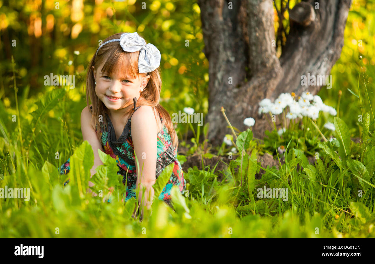 Funny lovely little girl in park Stock Photo - Alamy
