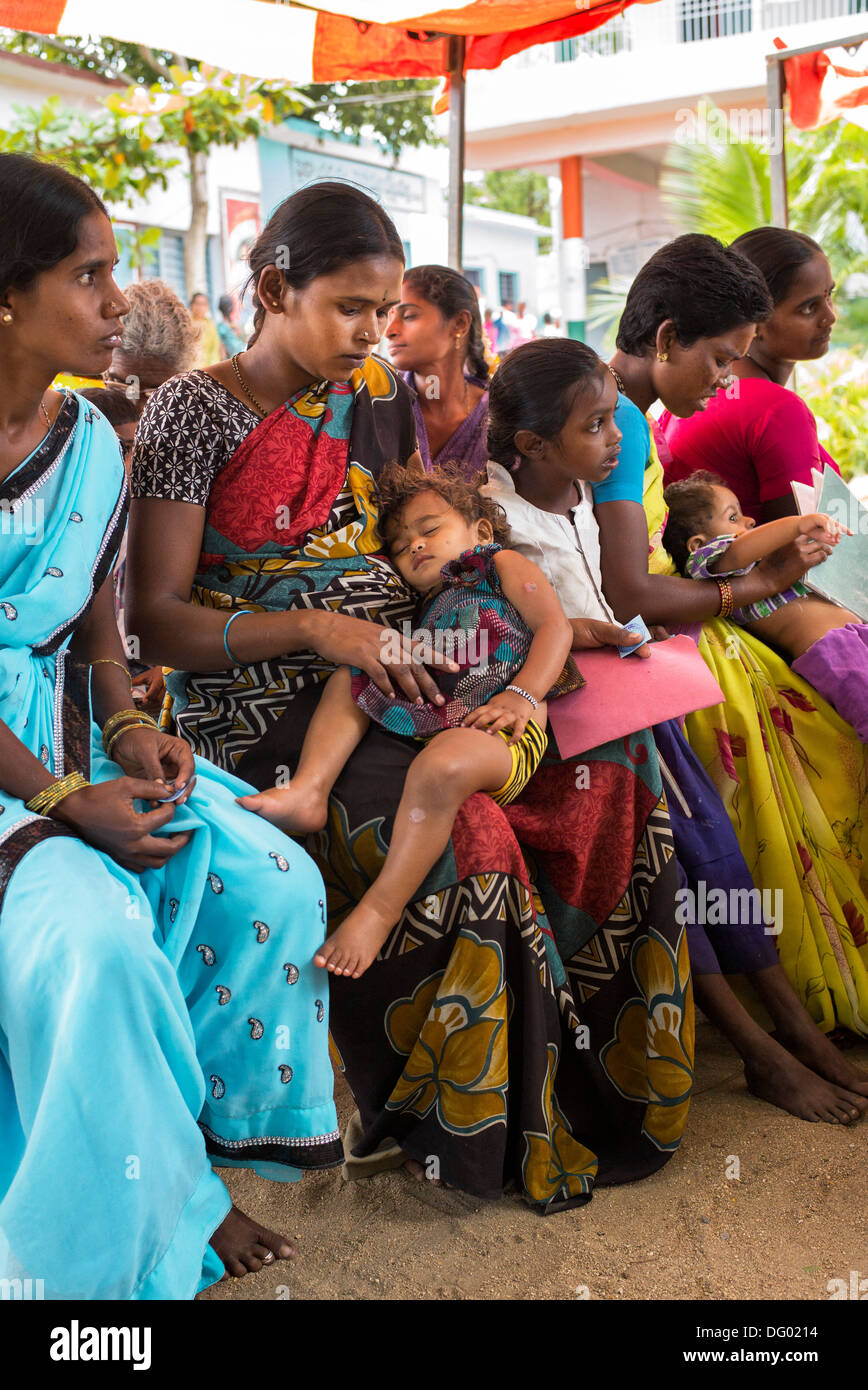 Rural Indian women in pediatric waiting area at Sri Sathya Sai Baba mobile outreach hospital clinic. Andhra Pradesh, India Stock Photo