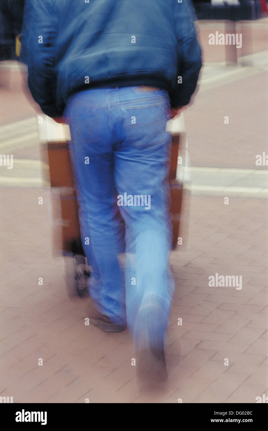 Man pushing a trolley Stock Photo Alamy