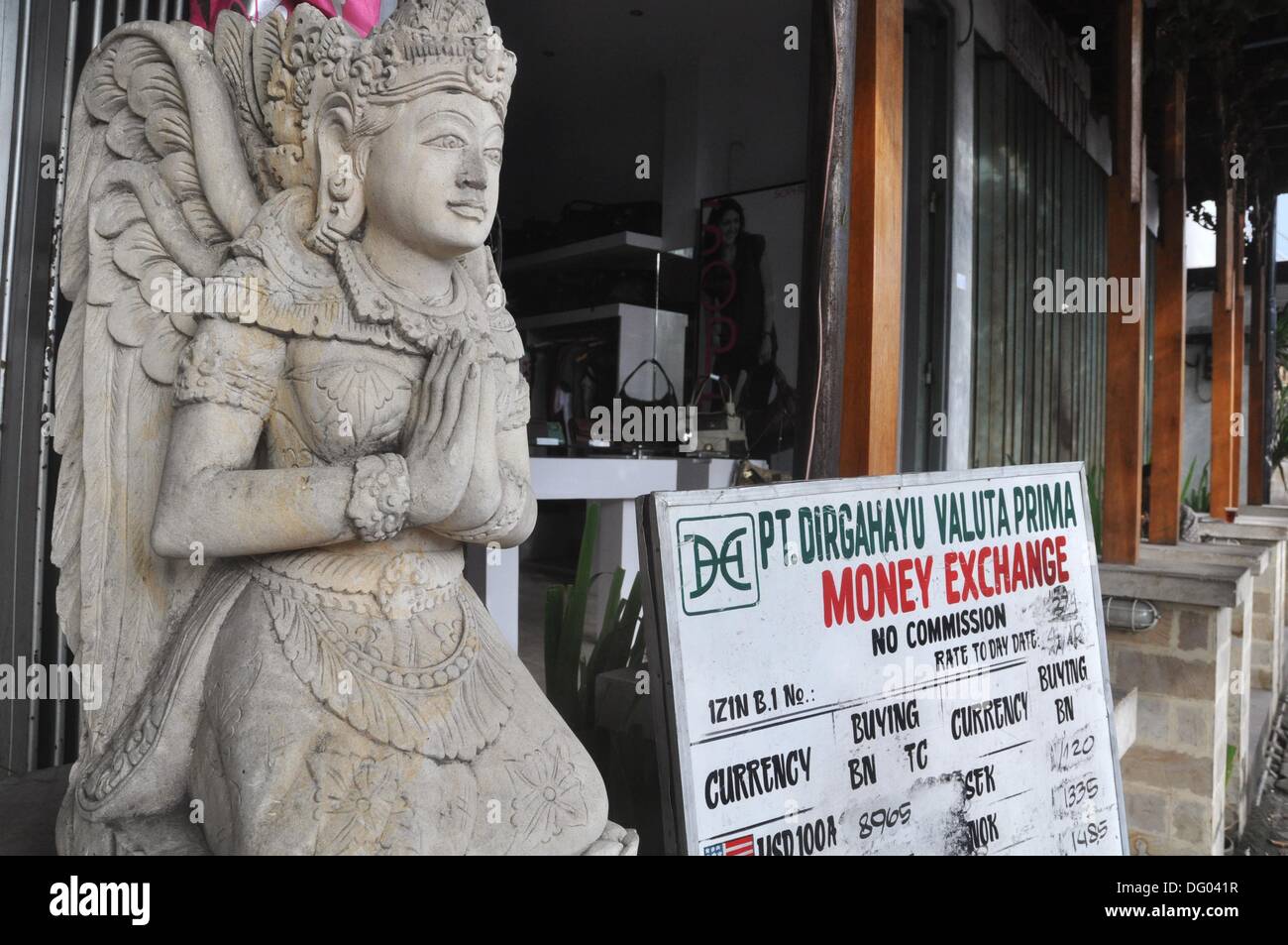 Kuta Beach (Bali, Indonesia) a money changer, with an Hindu statue at