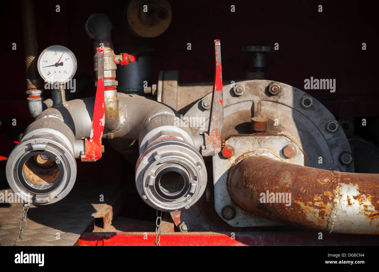 Water pump with hydrants. Firefighters Equipment of old fire truck Stock Photo