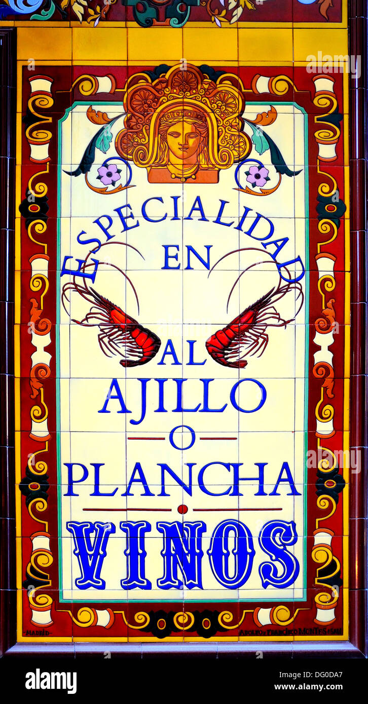 Madrid, Spain. Painted tiled restaurant sign. Wines (vinos) and Speciality - prawns in Garlic Stock Photo